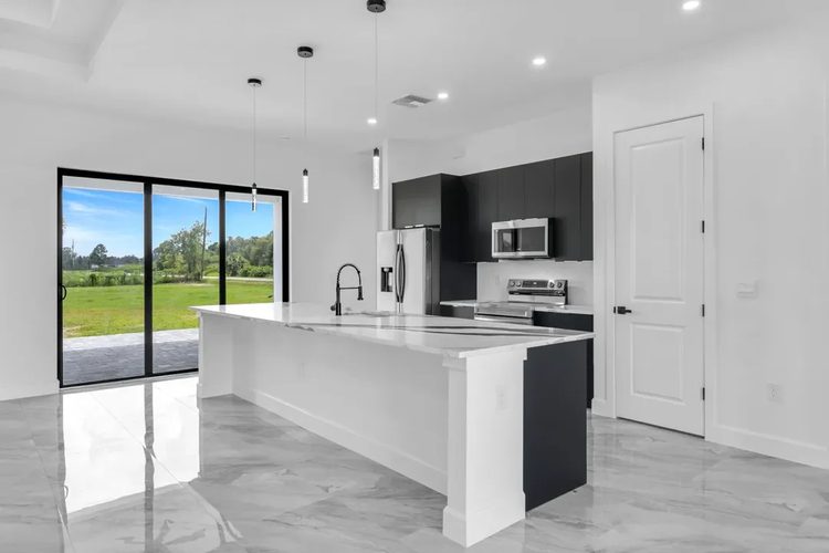 Kitchen with sliding doors to the back of the lot.