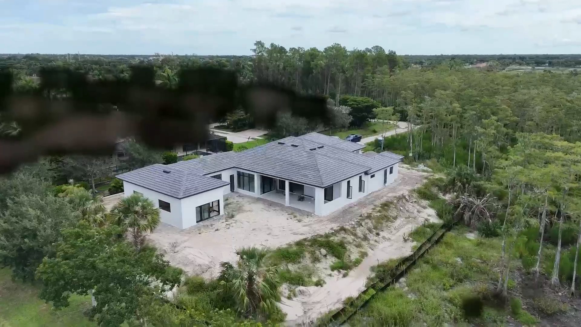 Custom home by Alexander² Construction on a wooded lot in Naples, Florida